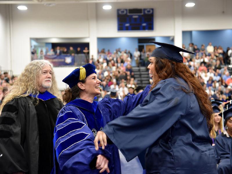 A Penn State Altoona graduate is congratulated by faculty